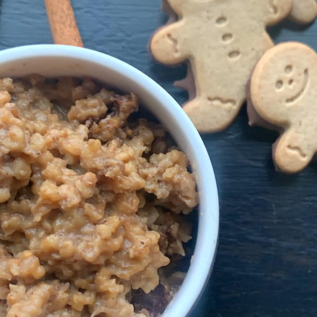 Oatmeal close up with gingerbread men cookie in the background