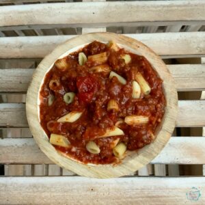 Looking down on a round wooden bowl of goulash