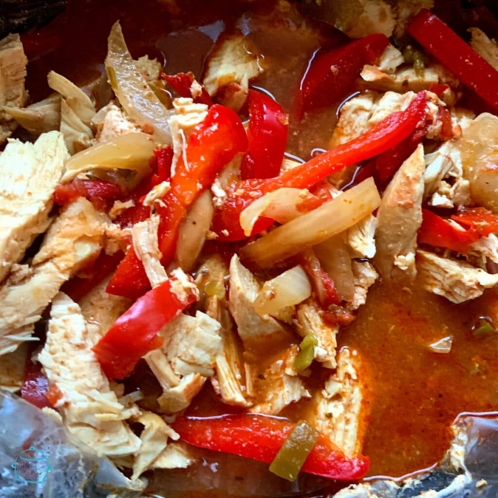 All fajita ingredients in slow cooker right after cooking