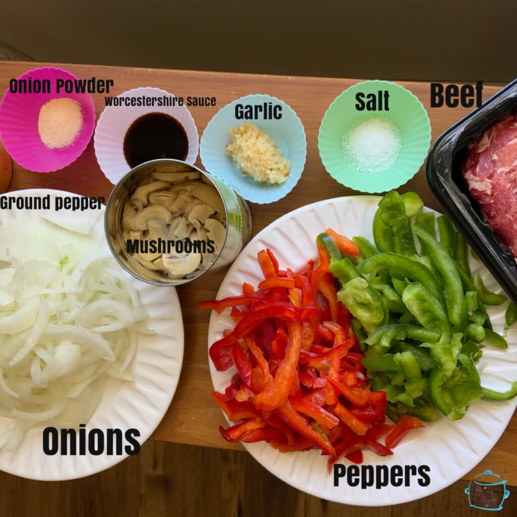 All steak sandwich ingredients on a table with labels