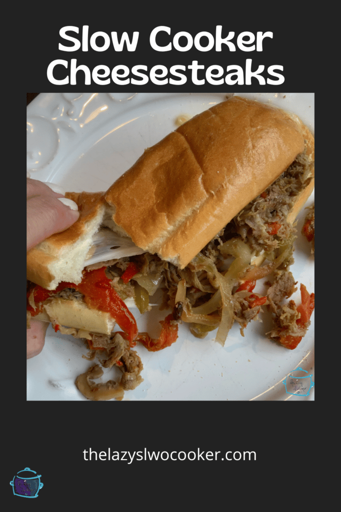 a hand pulling apart a Philly cheesesteak made in a slow cooker