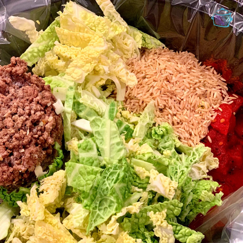 Some ingredients of crockpot unstuffed cabbage rolls in a slow cooker