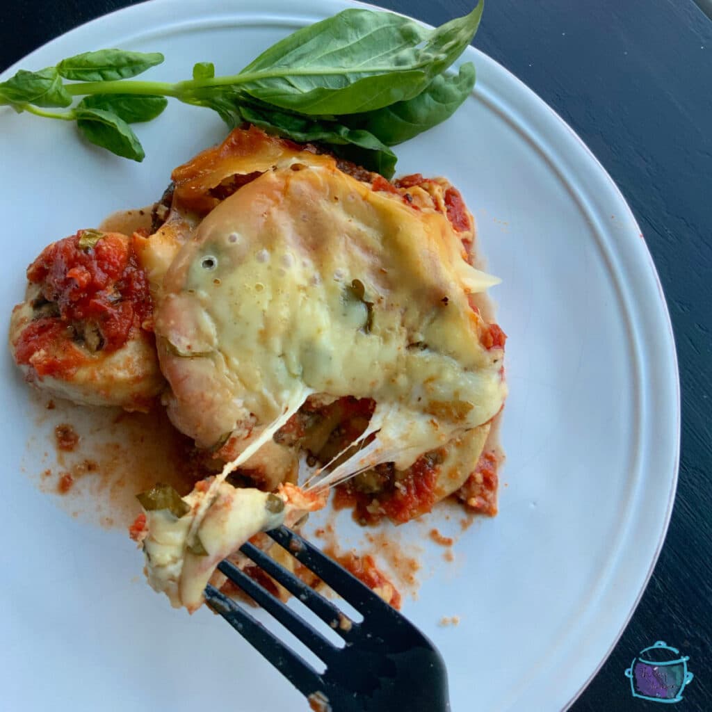 A fork holding a piece of eggplant bake