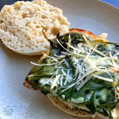 Egg sandwich on English Muffin with spinach made in slow cooker on a plate