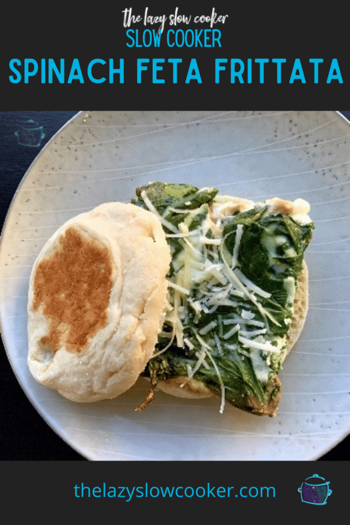 a slice of slow cooker spinach and feta frittata on an English muffin topped with some shredded parmesan cheese