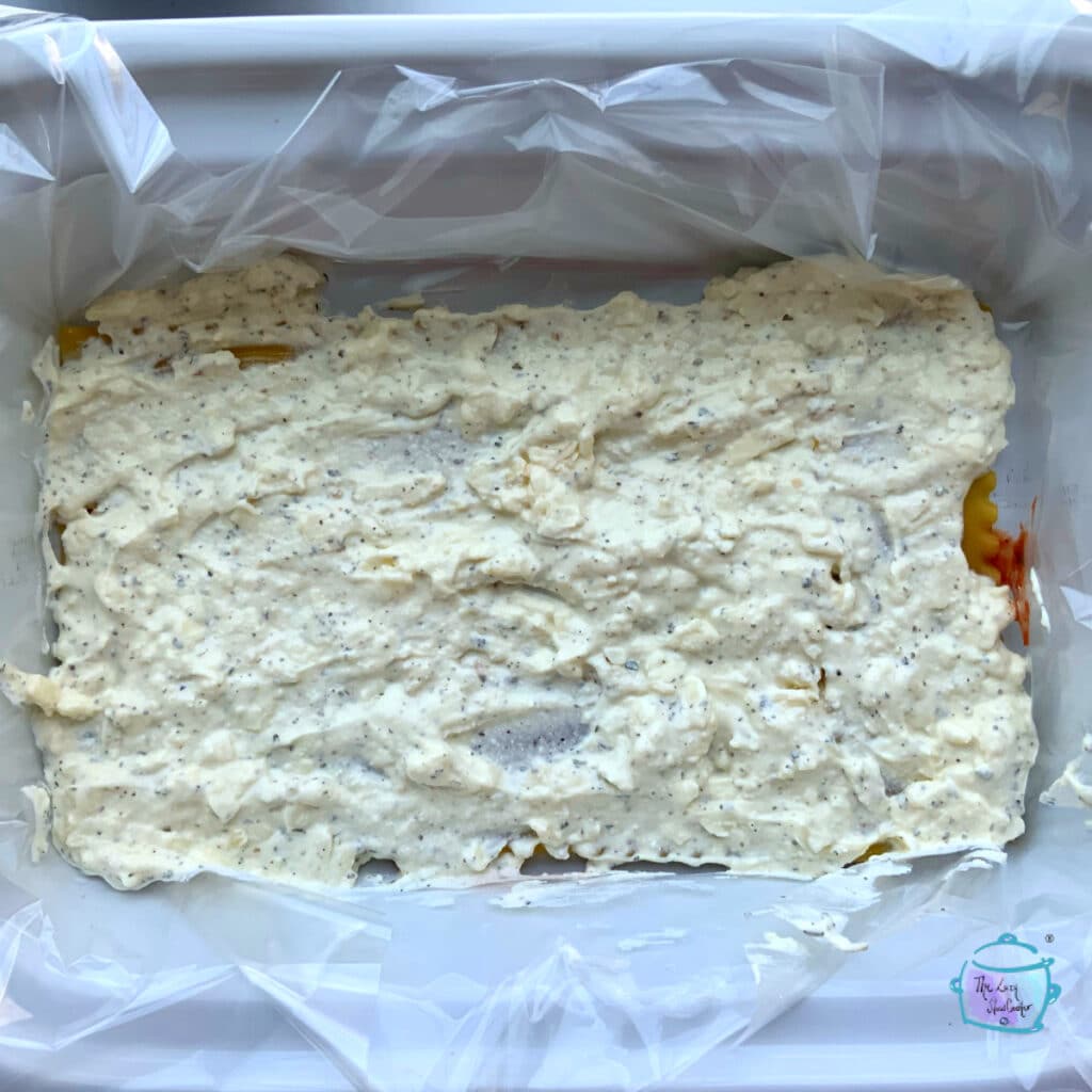 view of cheese layer of lasagna in slow cooker