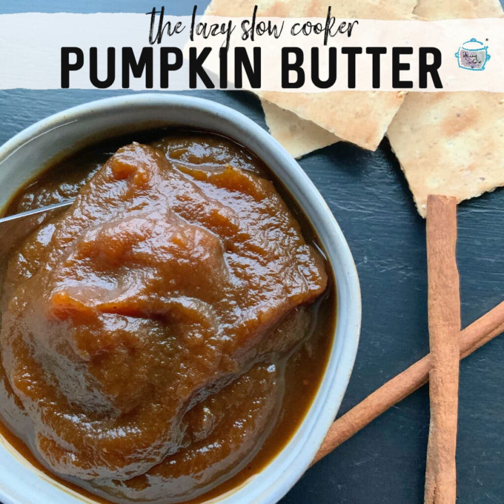  a bowl filled with pumpkin butter with some cinnamon sticks off to the side