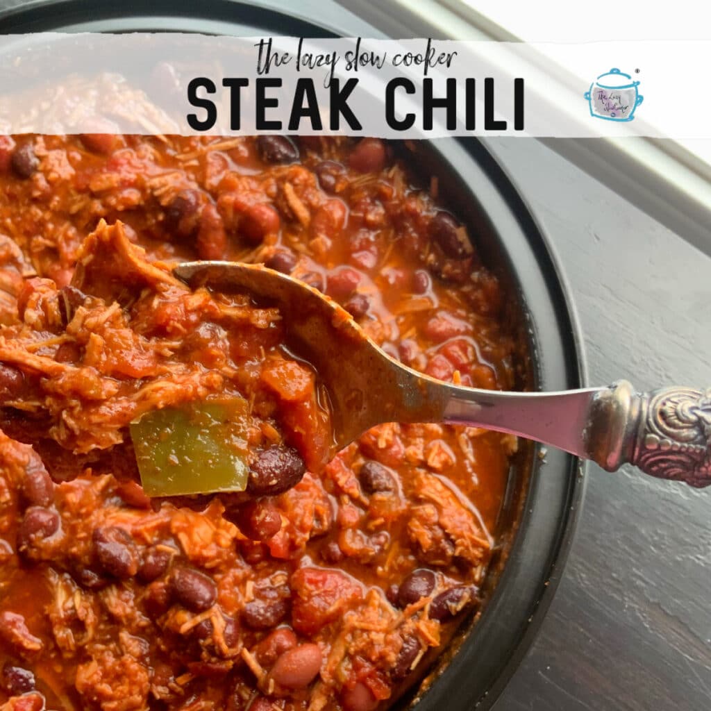 a round black bowl filled with shredded beef and bean chili