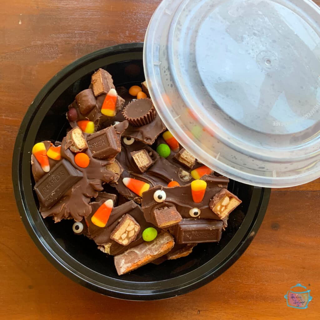 Leftover slow cooker candy bark in a freezer container