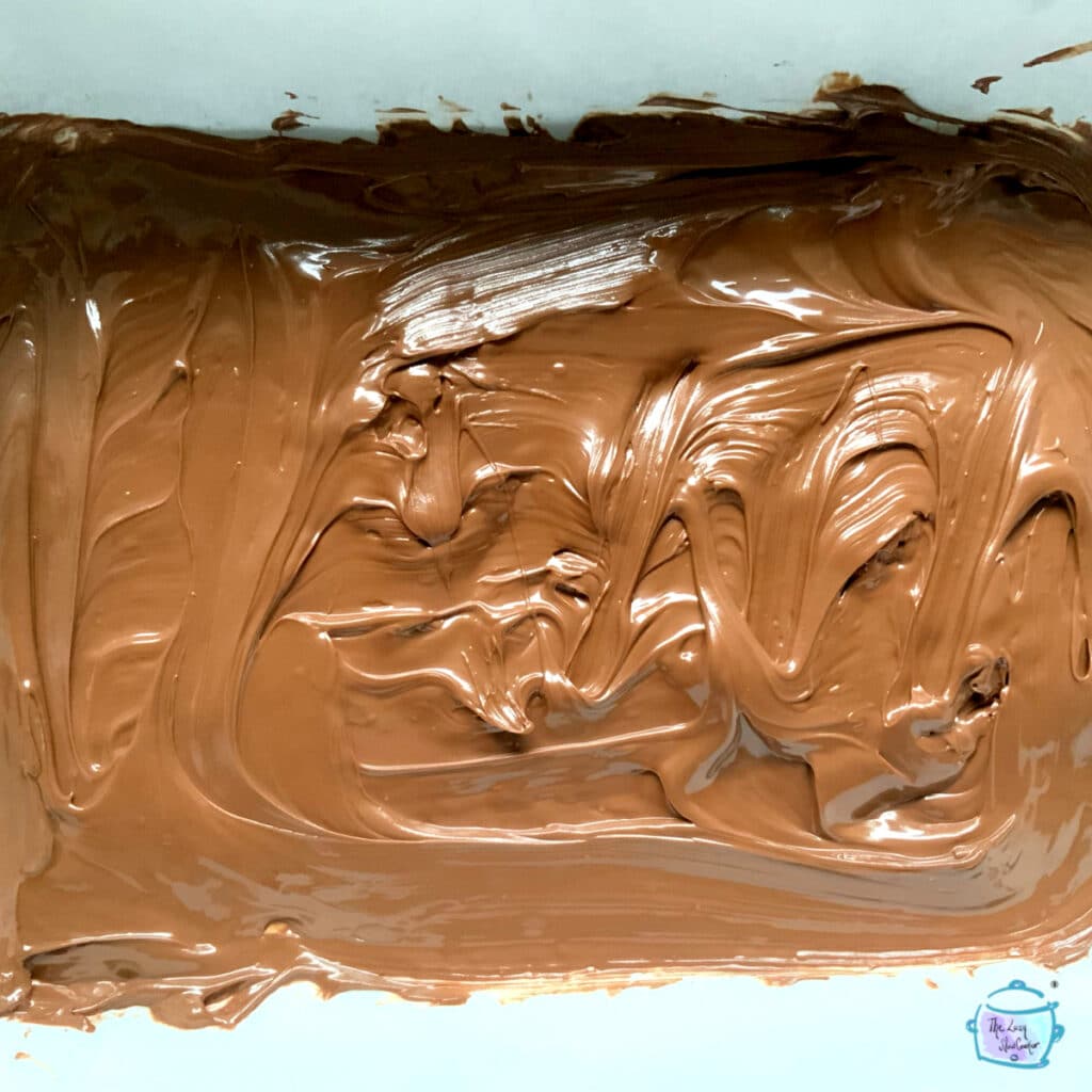 Melted chocolate smoothed into one layer in slow cooker