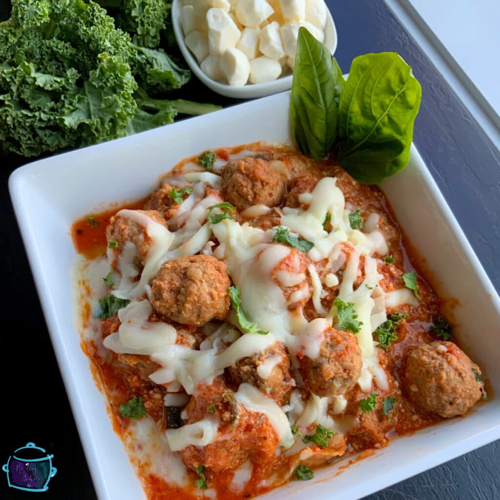 Cheesy meatball casserole in a square bowl