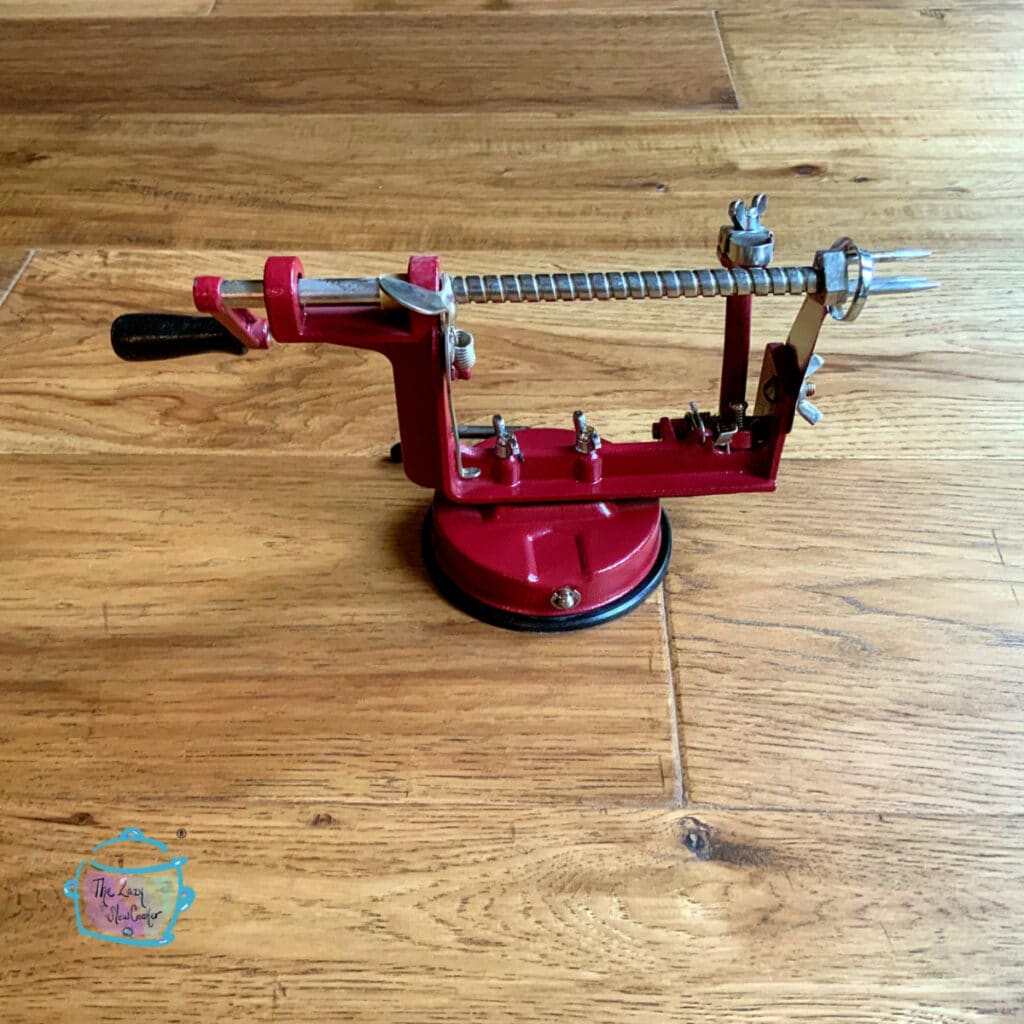 Apple corer/peeler on a wooden surface