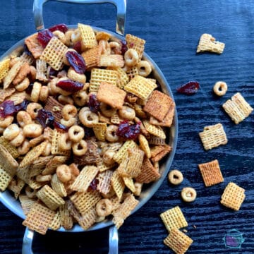 Close up of snack mix in a round metal pan