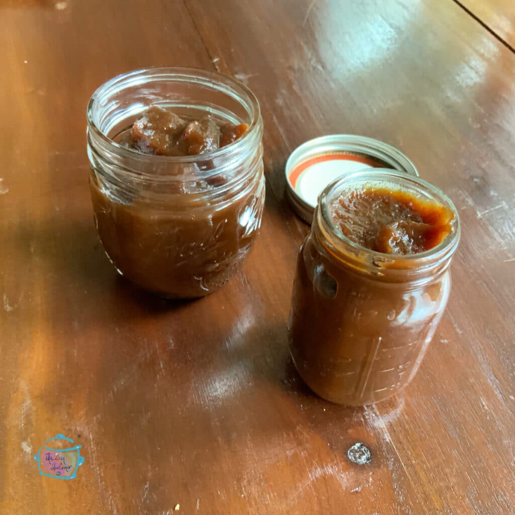 Two small jars of apple butter without lids