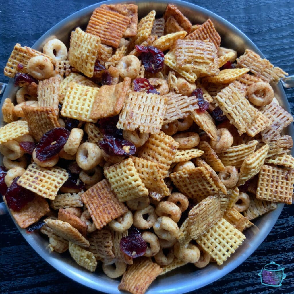 Close up of chex mix in a round metal bowl