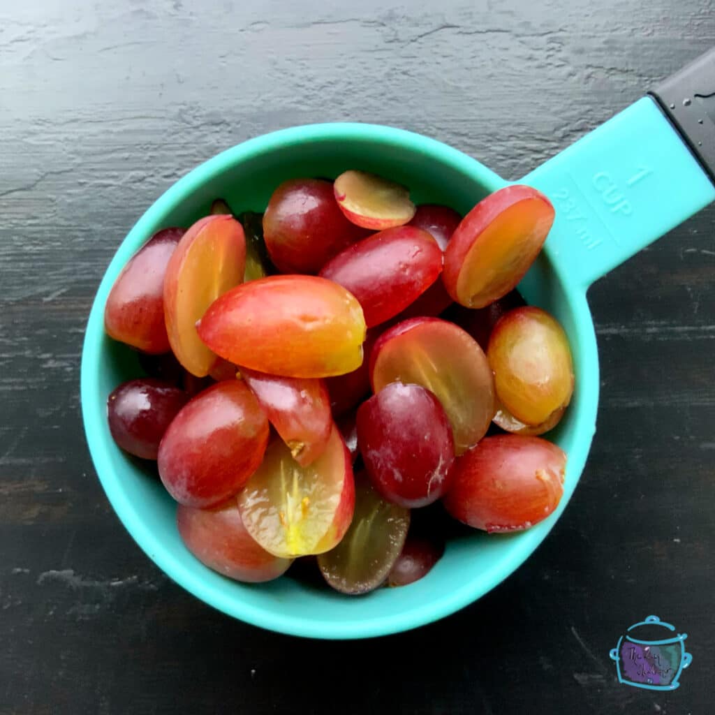 Cut grapes in a measuring cup