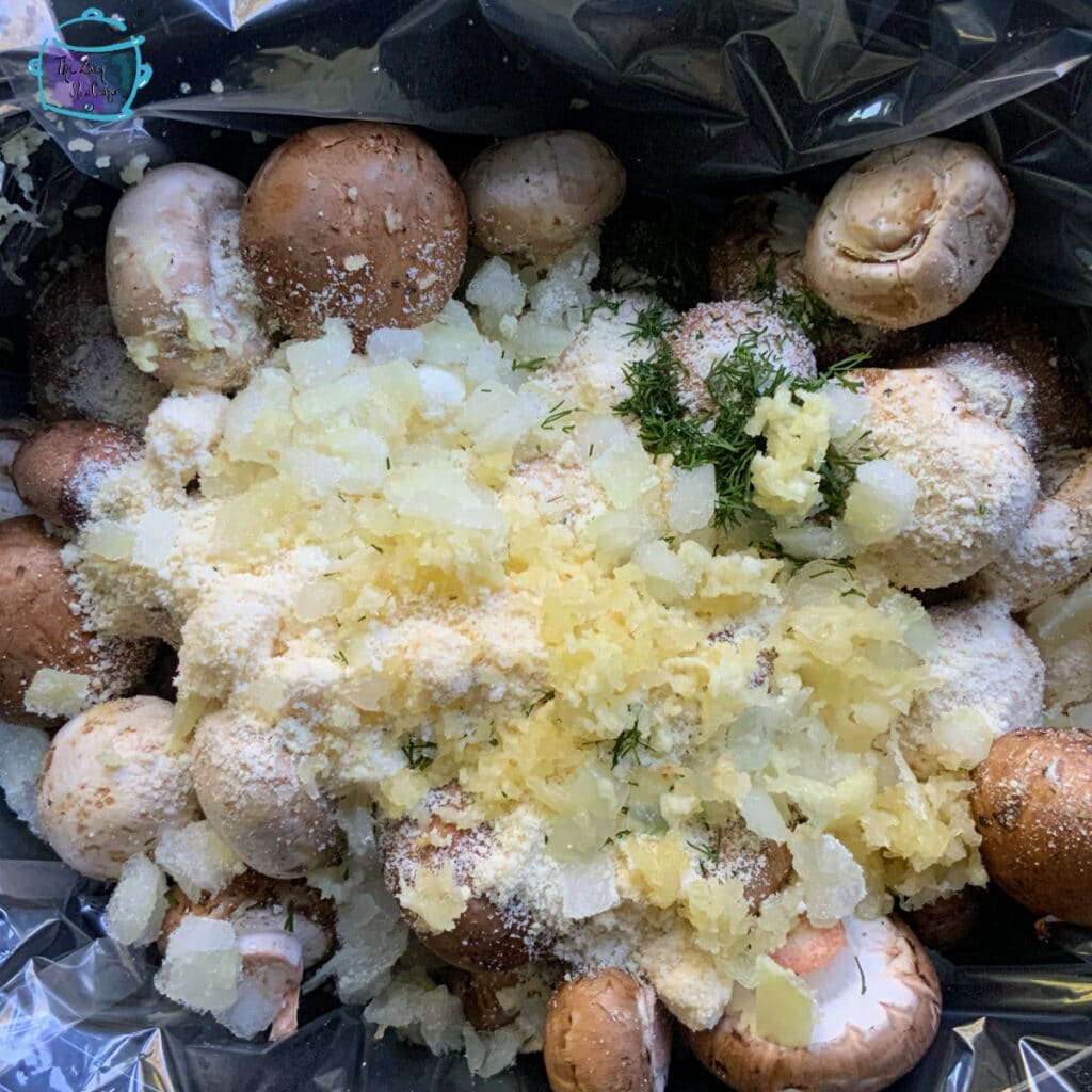 All slow cooker garlic parmesan mushroom ingredients in slow cooker prior to cooking