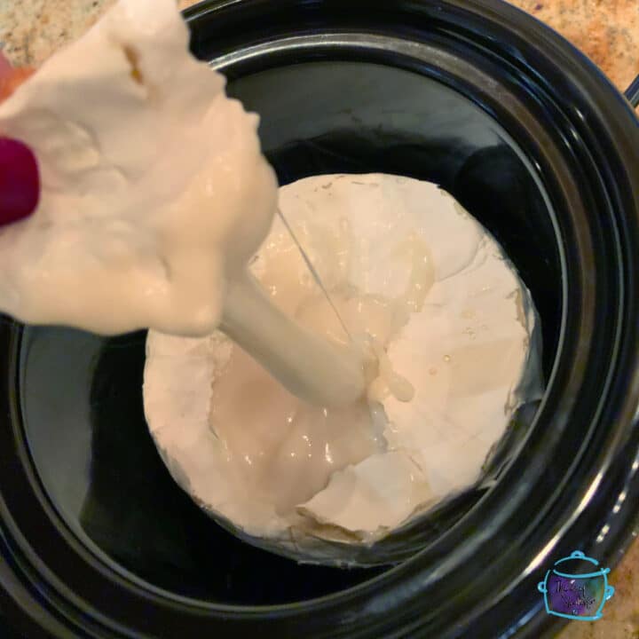 Slow Cooker Baked Brie with Pesto & Sun-Dried Tomato - The Lazy Slow Cooker