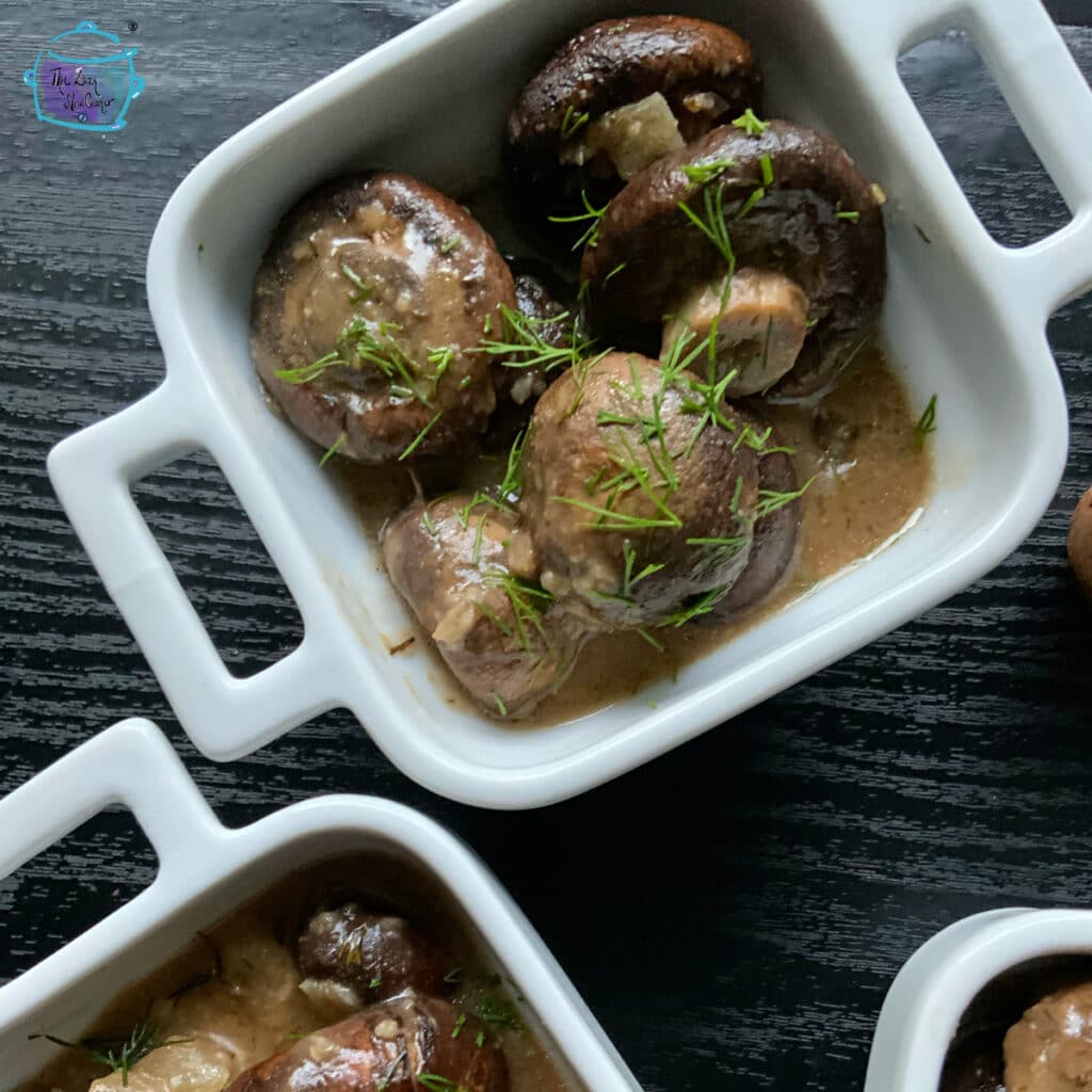 A close up of mushrooms topped with fresh dill