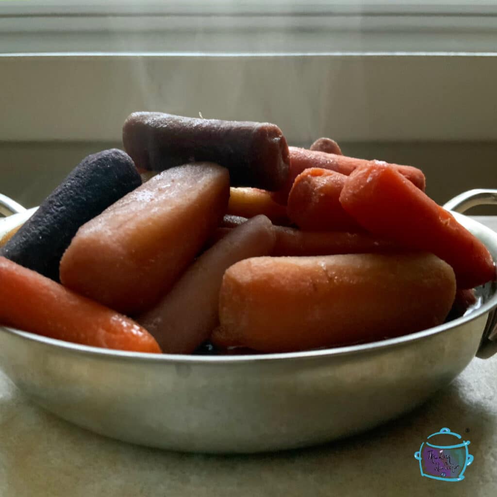 side view of finished carrots with steam rising