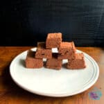 Pieces of chocolate fudge in a pyramid on a white plate