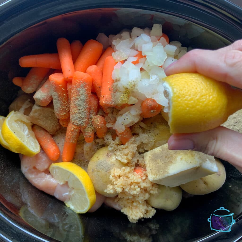 Squeezing fresh lemon juice over chicken in slow cooker