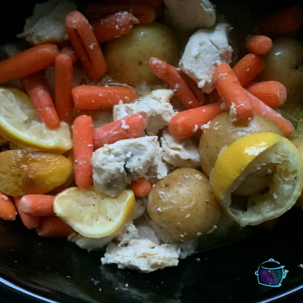 Slow cooker lemons peppers chicken in crockpot after cooking