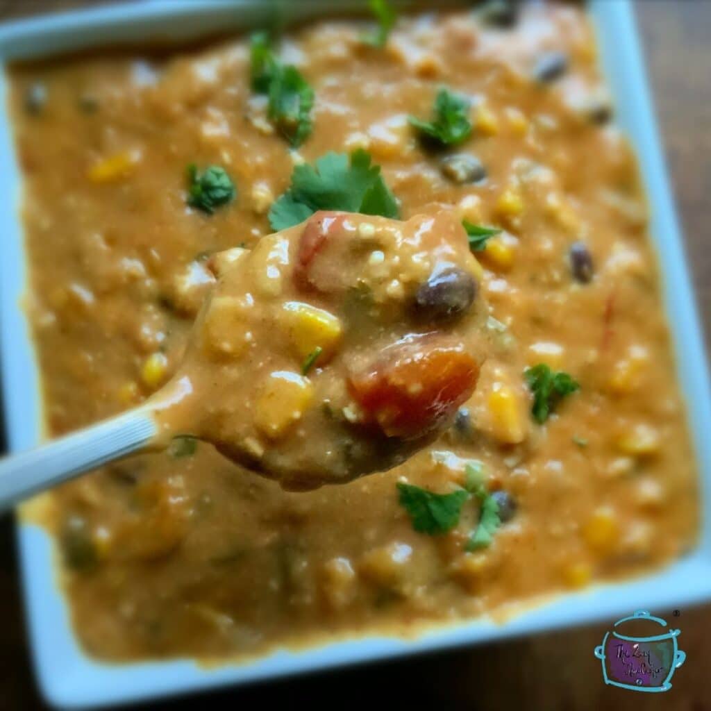 A finished bowl of vegan fiesta soup garnished with some fresh chopped cilantro