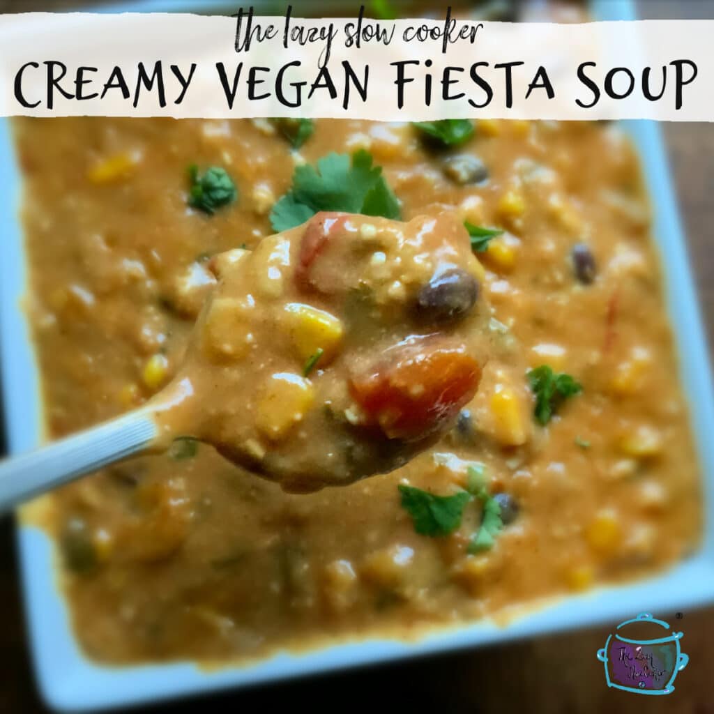 a square bowl of creamy fiesta soup with beans and veggies