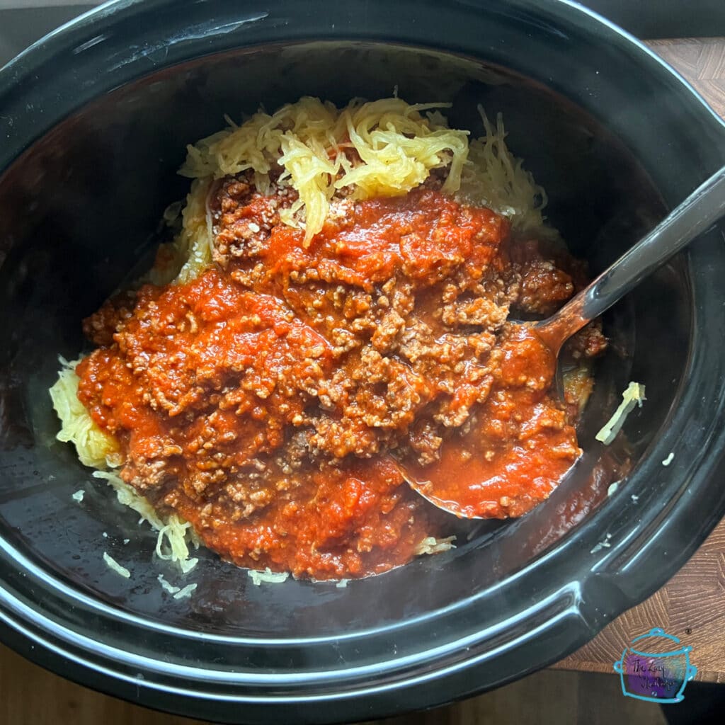 Squash with sauce in slow cooker before mixing