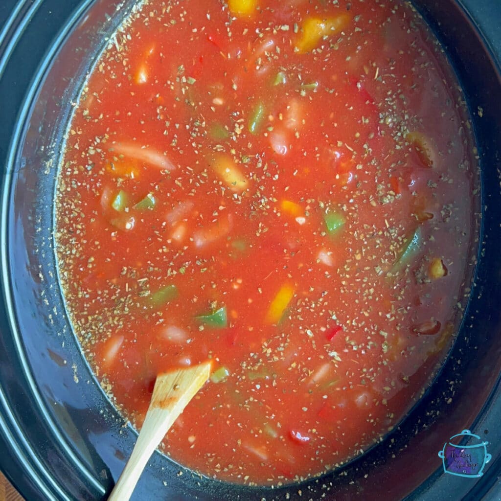 All soup ingredients but ravioli and spinach in slow cooker