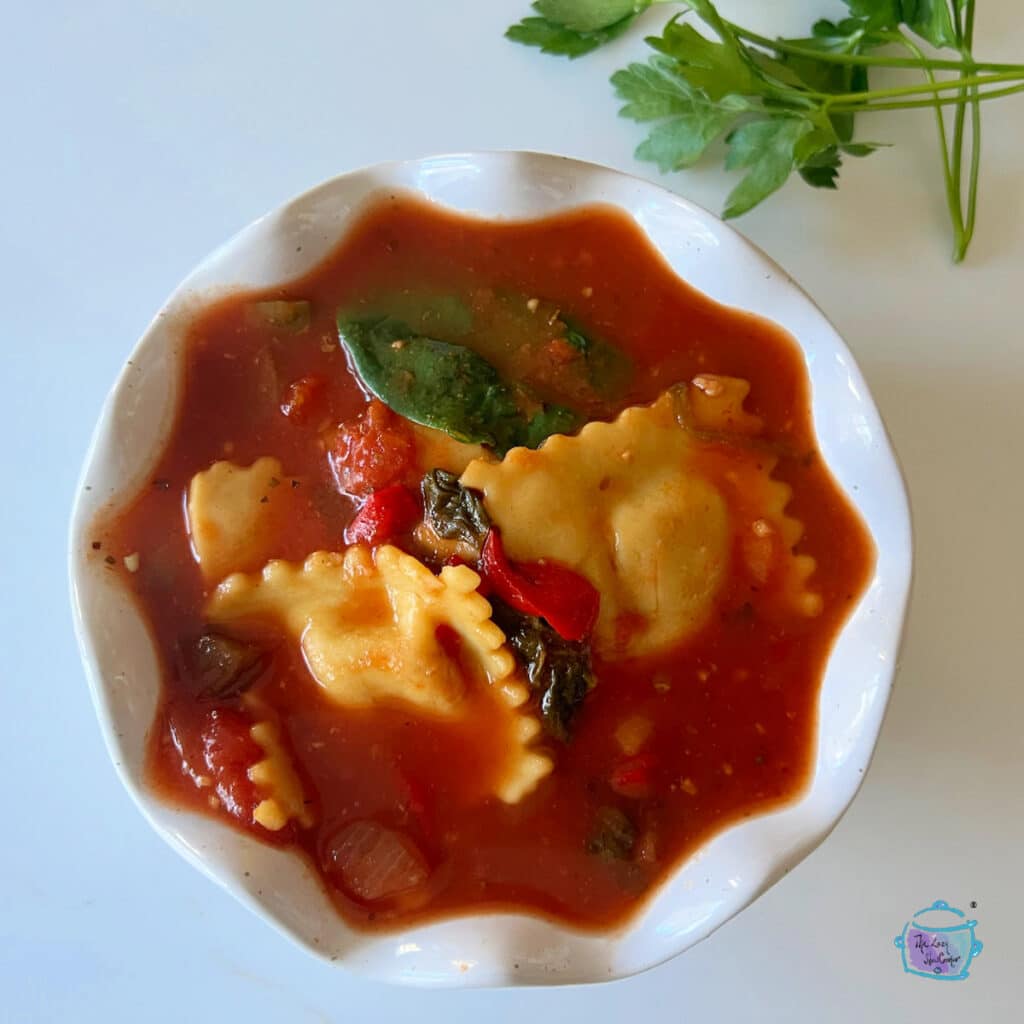 Ravioli soup in a white bowl