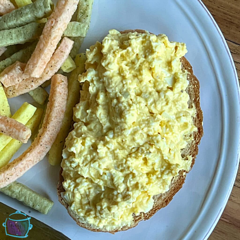 Close up of crockpot egg salad on rye bread 