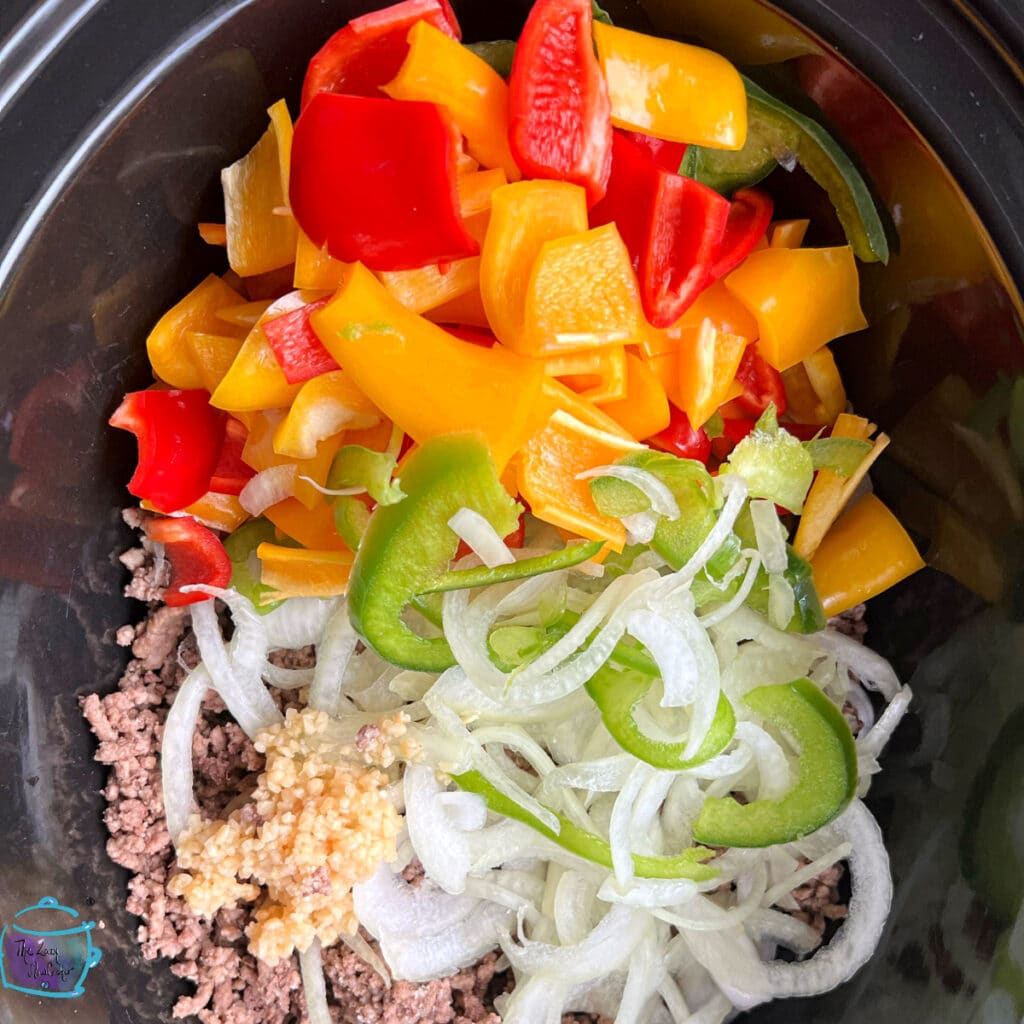 All meat and veggies in pepper soup in crockpot before cooking