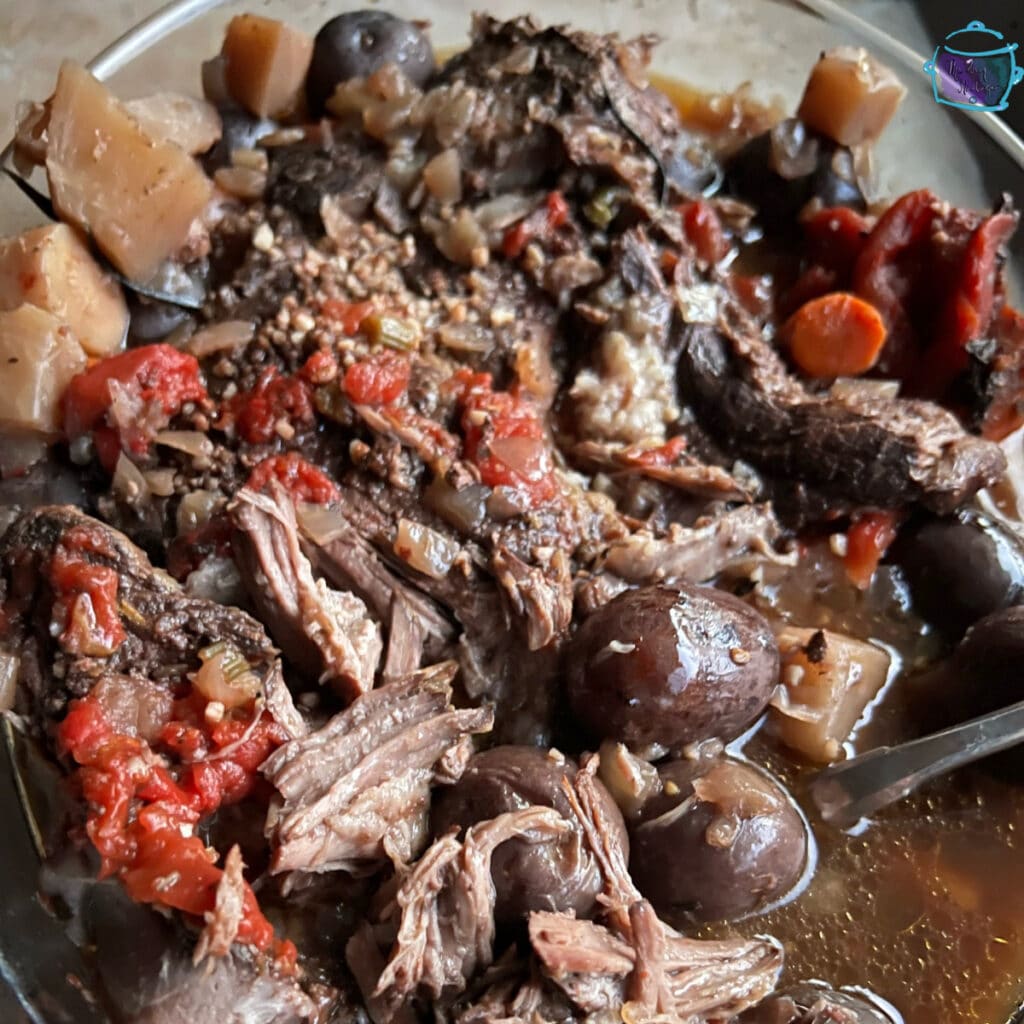 side view of a finished plate of pot roast and veggies ready to serve