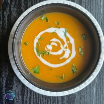 Finished bowl of butternut squash soup with coconut milk swirled on top