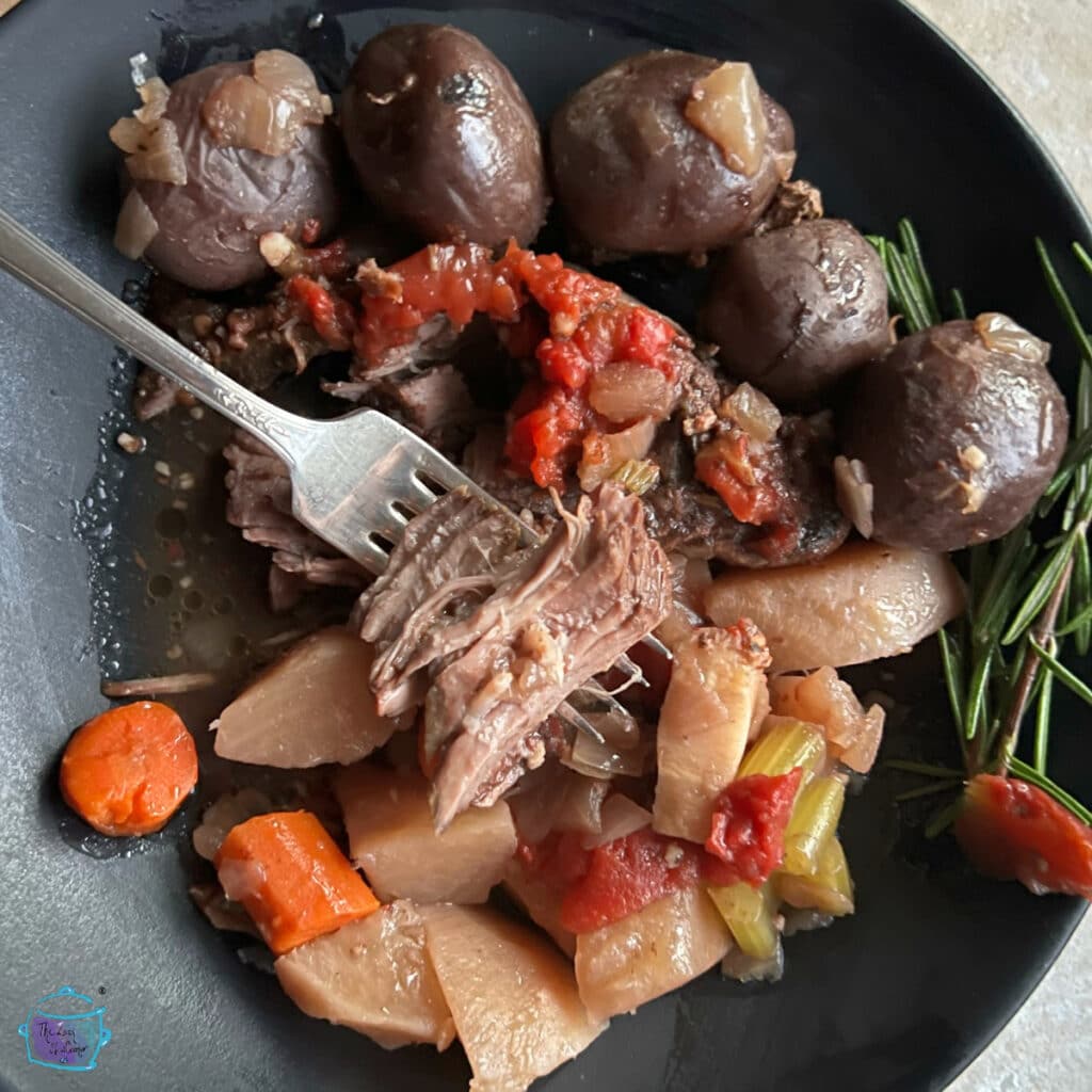 Yankee roast and veggies in a black bowl