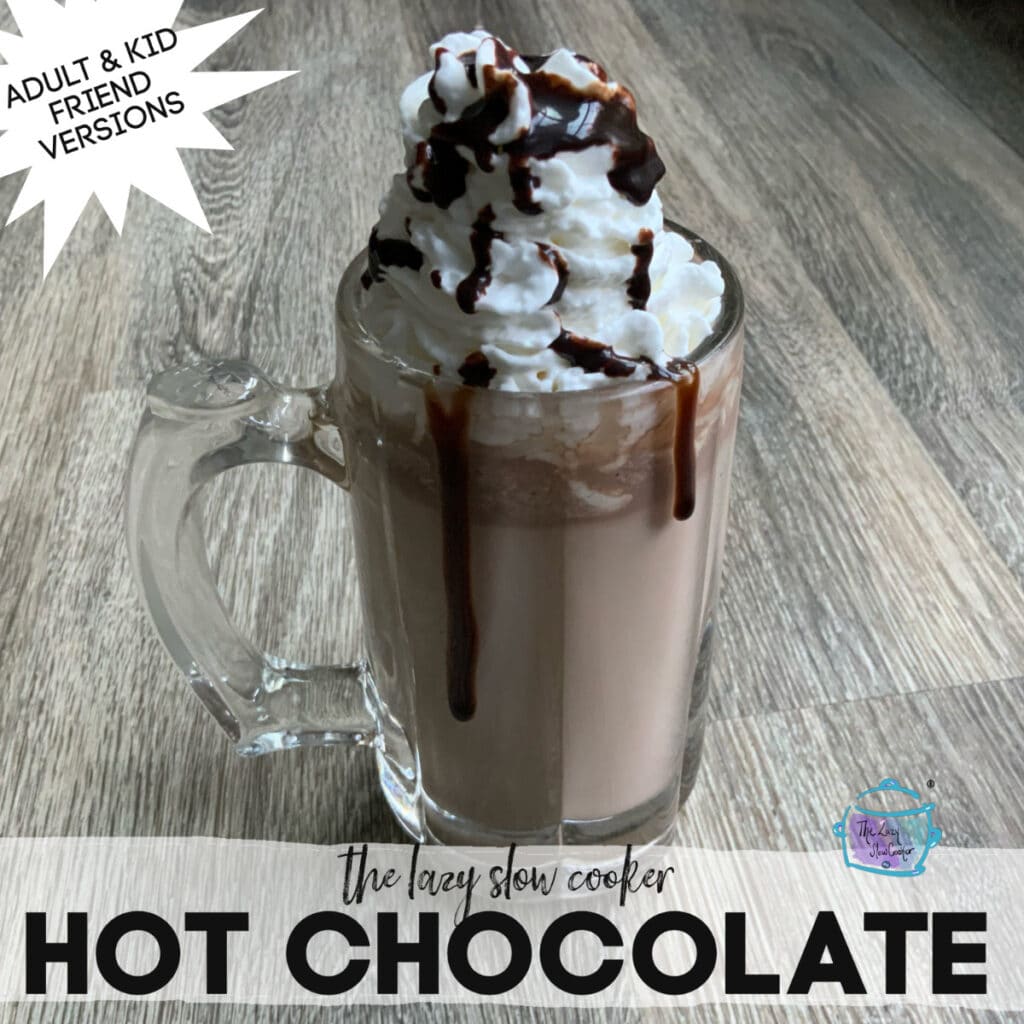 hot chocolate in a glass mug topped with whipped cream and chocolate syrup