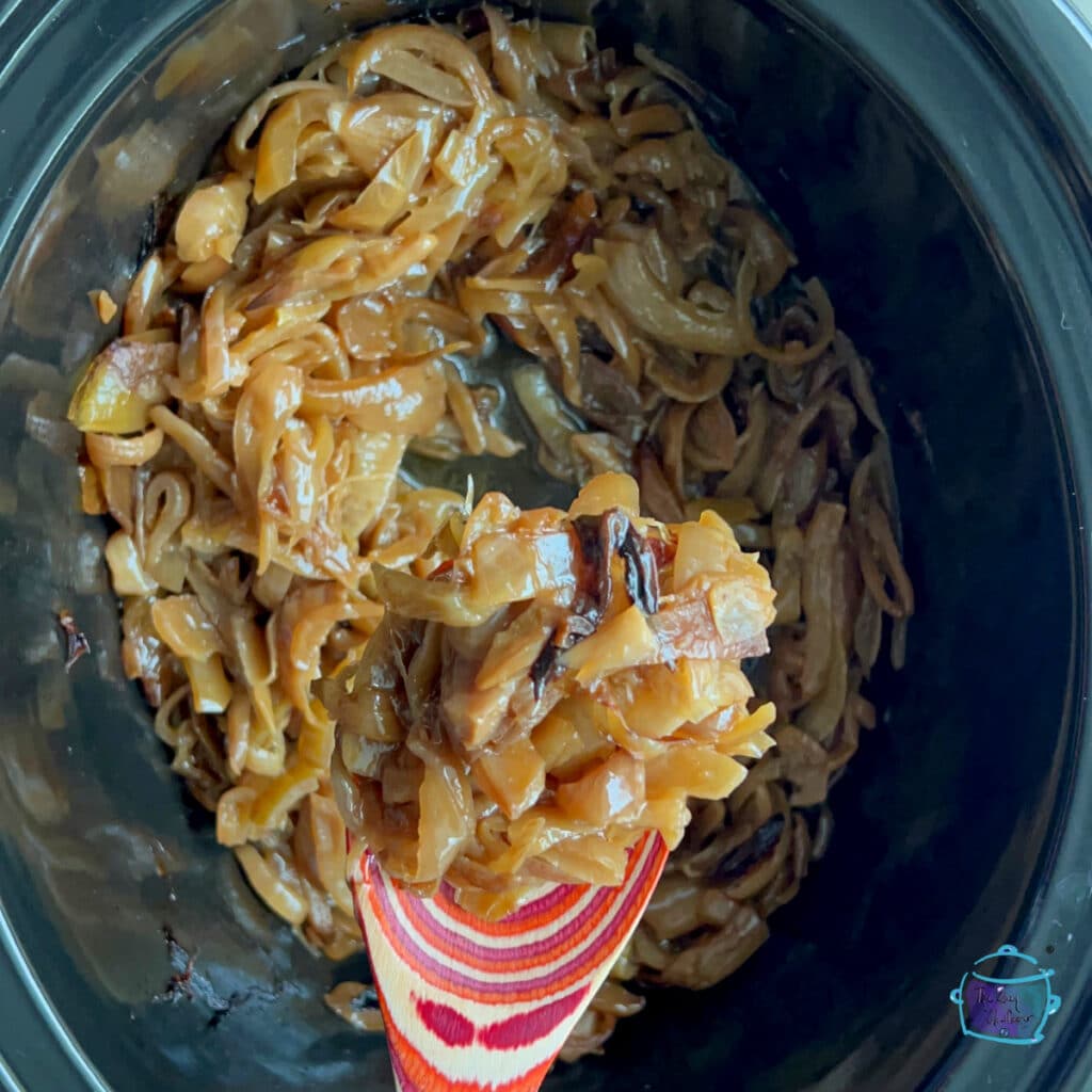 a slow cooker full of caramelized onions