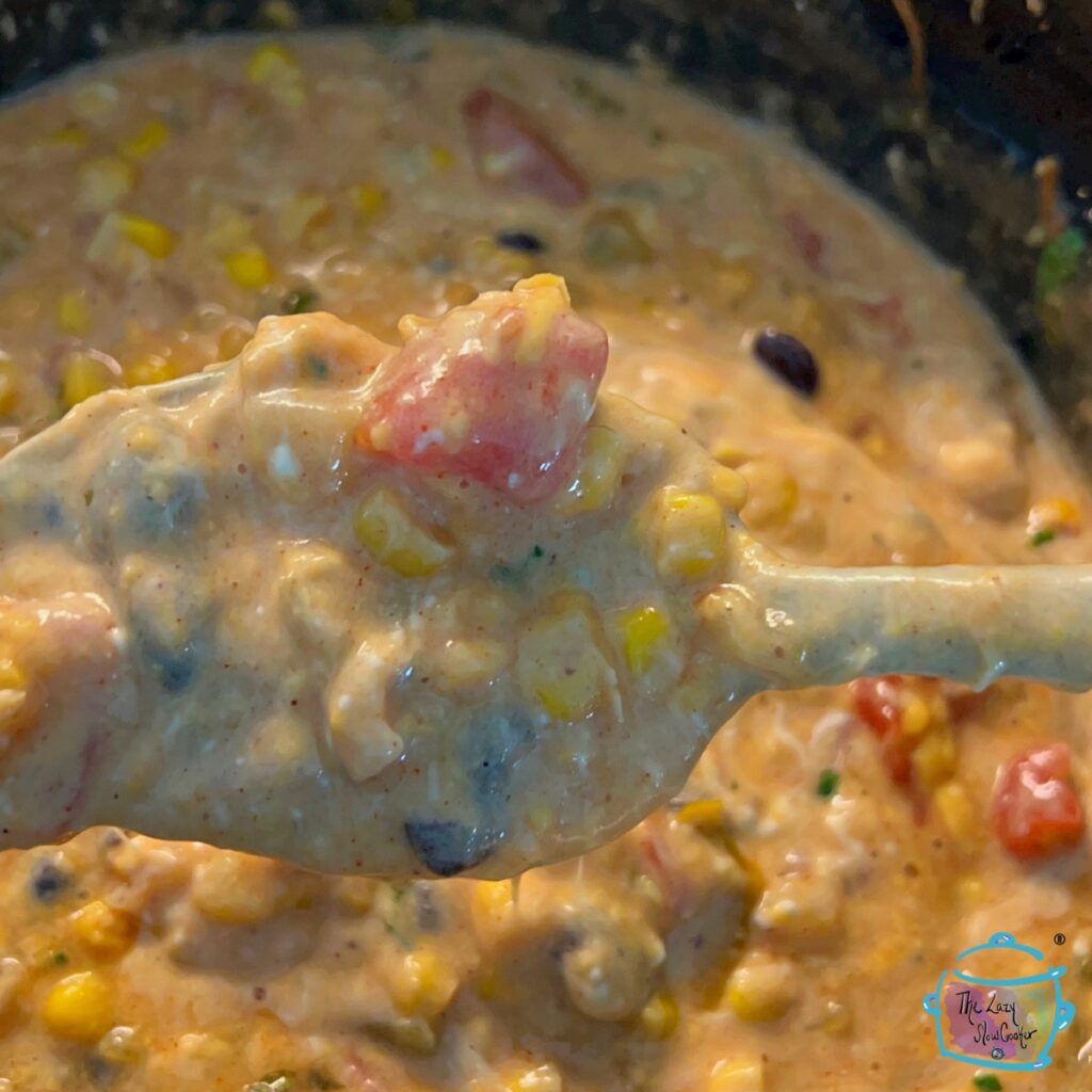 melted ip in slow cooker being held by a spoon