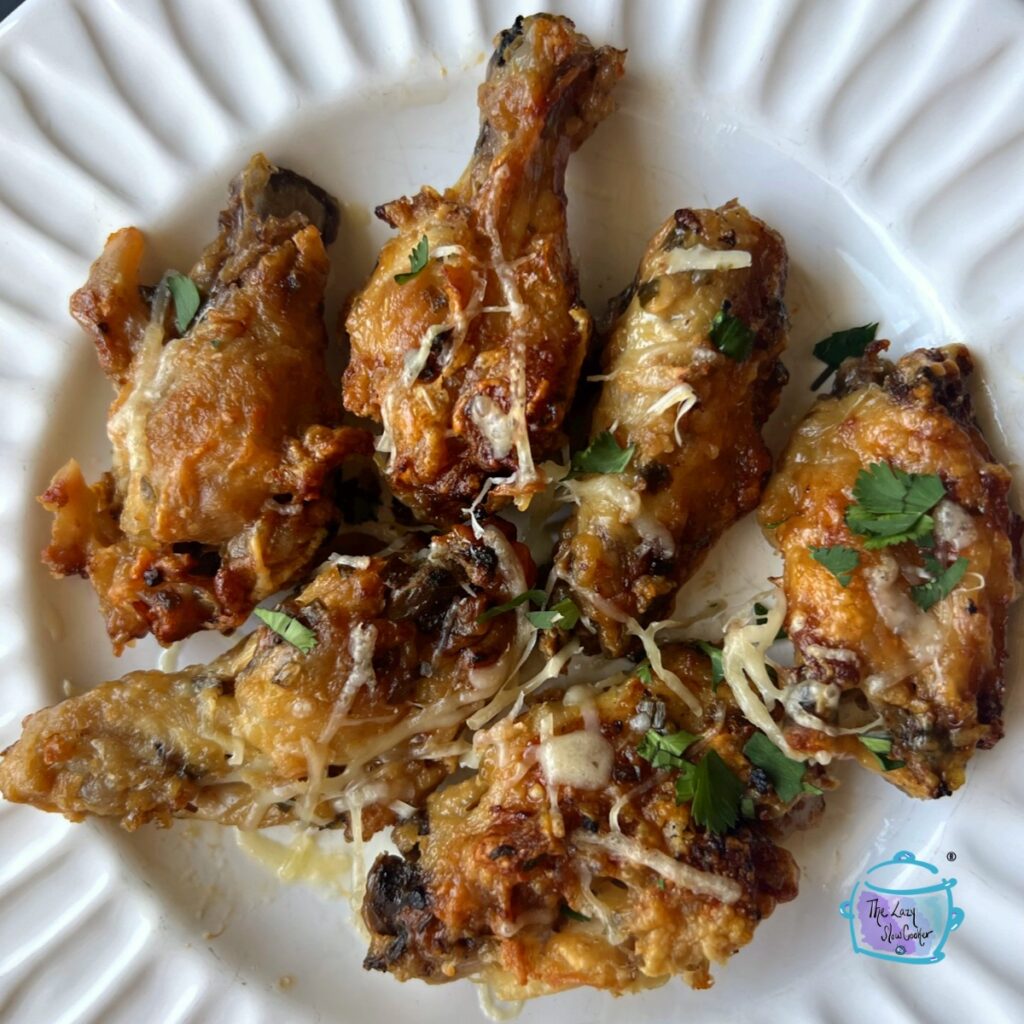 finished garlic parmesan wings on a white plate