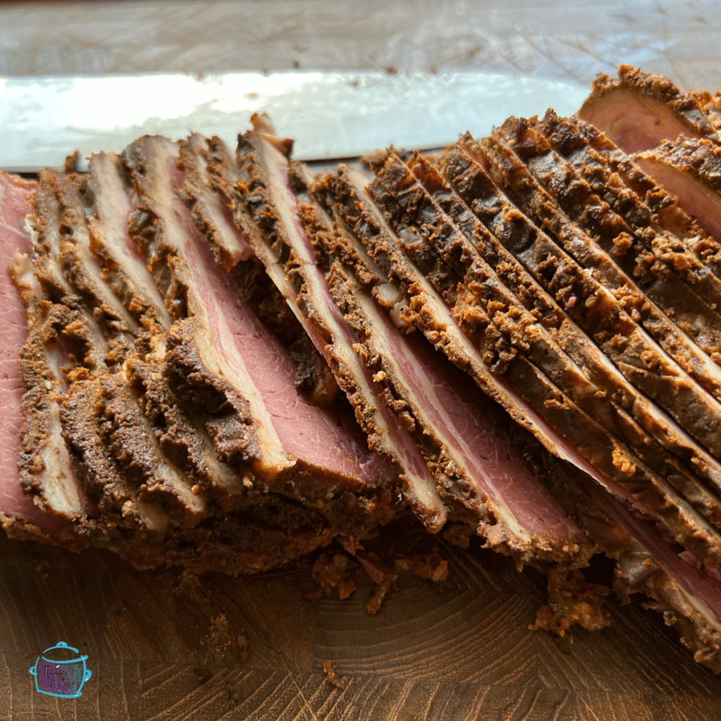 A side view of a just sliced slow cooker pastrami