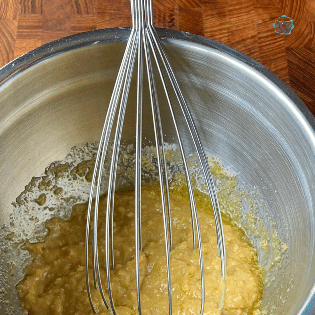 Dijon parmesan sauce being whisked together in a bowl