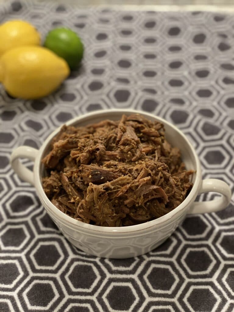 beef barbacoa shredded in a round white bowl