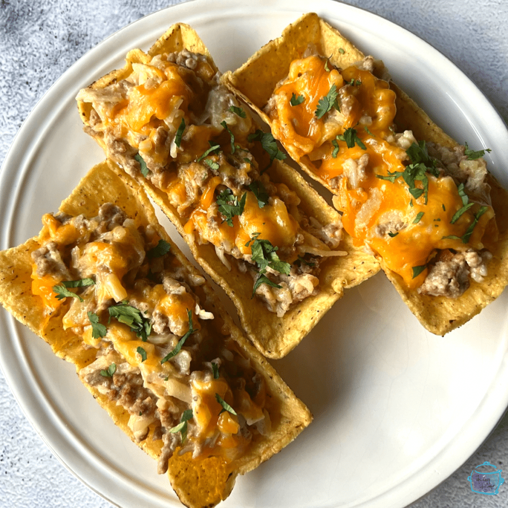 looking down one hash brown burger casserole in three different taco bowl shells