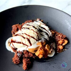 chocolate peanut butter brownie topped ice cream and chocolate syrup
