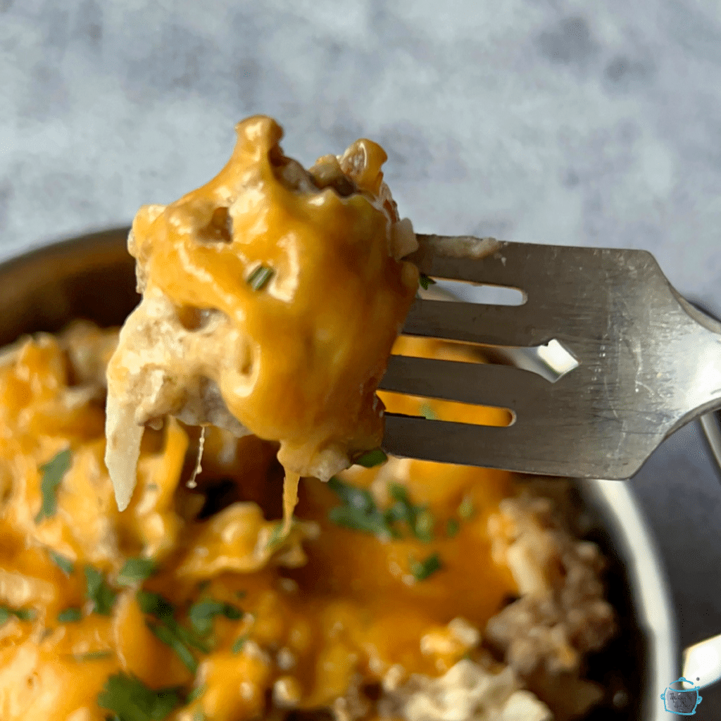 cheeseburger hash browns and melted cheese on a fork