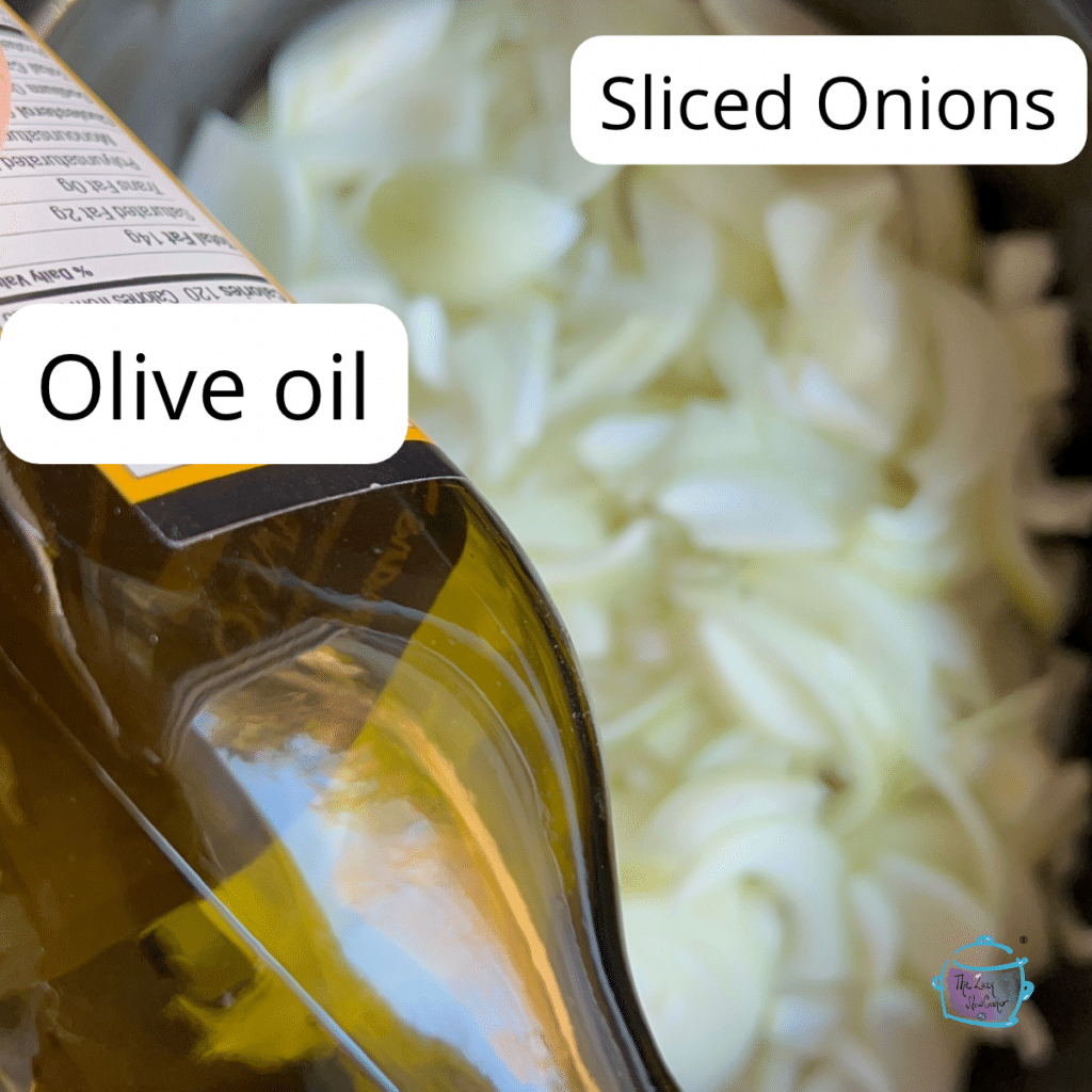 Sliced onions and olive oil in a slow cooker