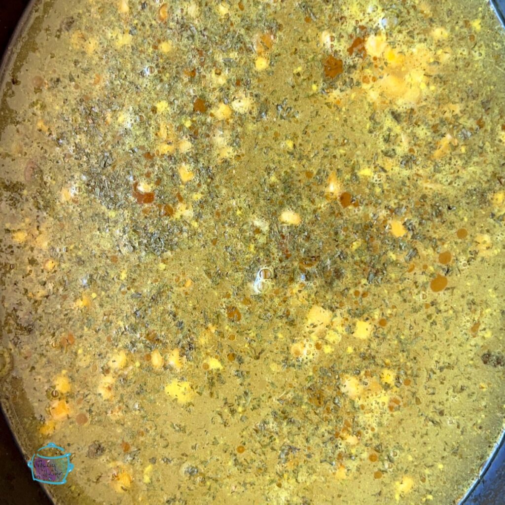 a crockpot full of chicken and corn soup ingredients before being cooked