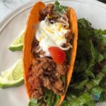 Close up of ground slow cooker turkey taco meat in a crunch taco shell